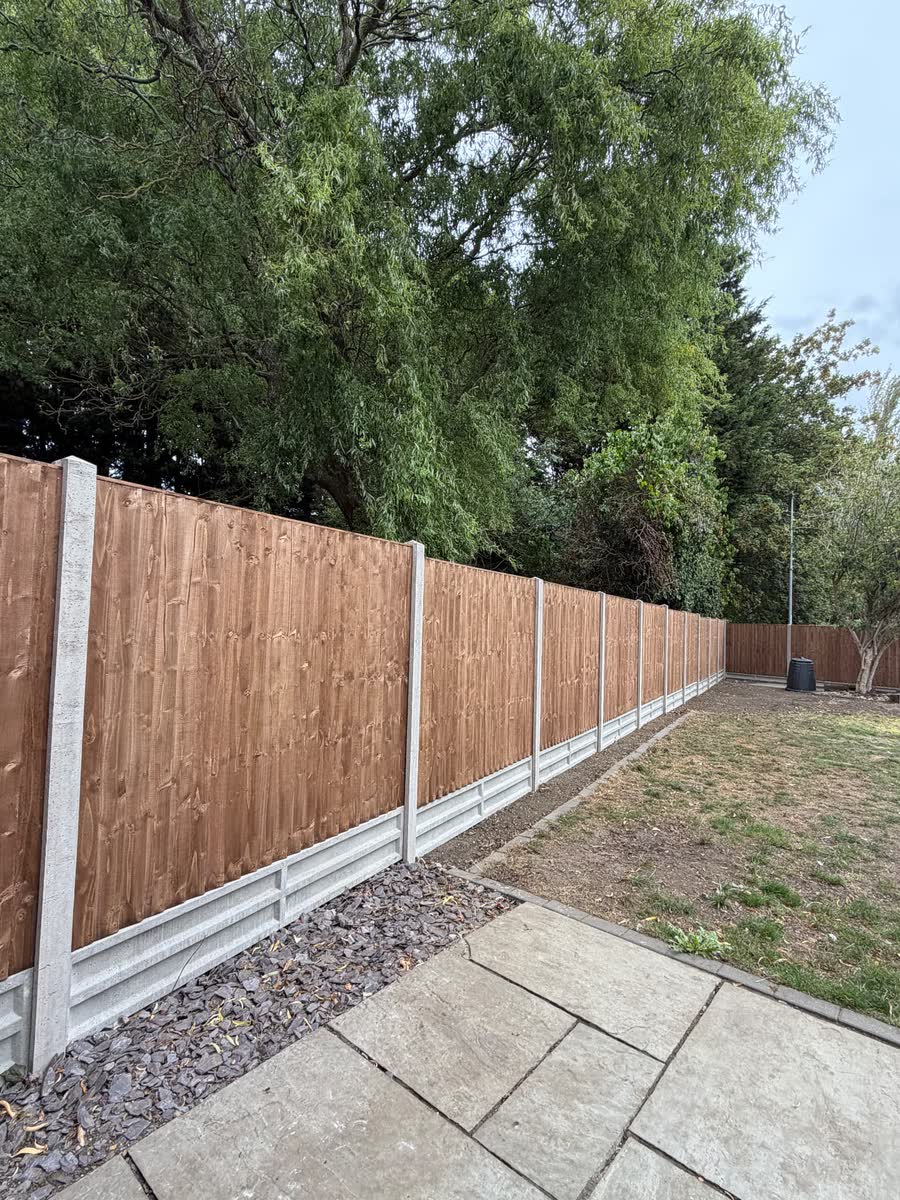 The full fence run, viewed from the patio — after